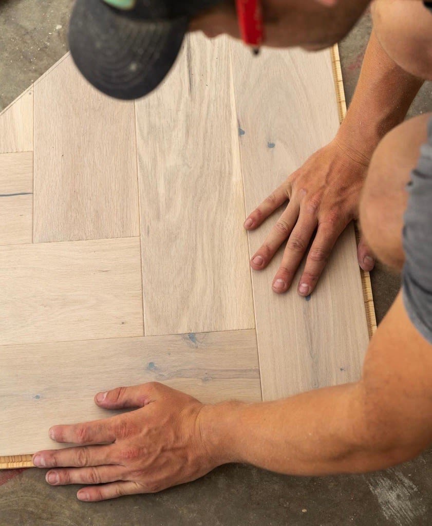 person putting in wood floor
